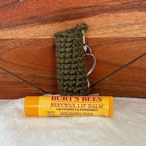 Handmade crocheted keychain lip balm case with a lip balm